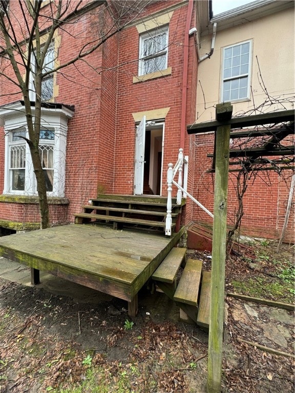 rear view of property with a wooden deck