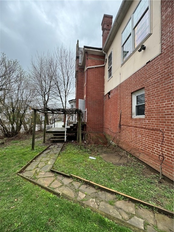 exterior space featuring a deck and a lawn