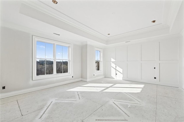 unfurnished room featuring a raised ceiling and crown molding