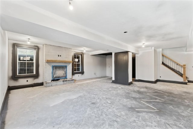 unfurnished living room featuring concrete floors