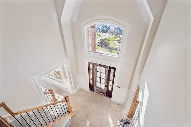 foyer entrance featuring a towering ceiling