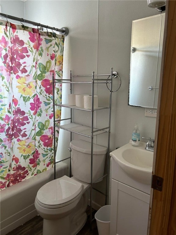 full bathroom featuring shower / bath combination with curtain, toilet, hardwood / wood-style flooring, and vanity