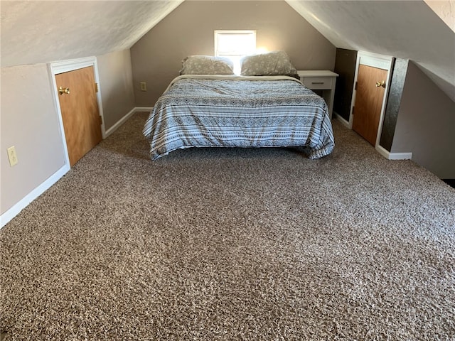 carpeted bedroom featuring lofted ceiling