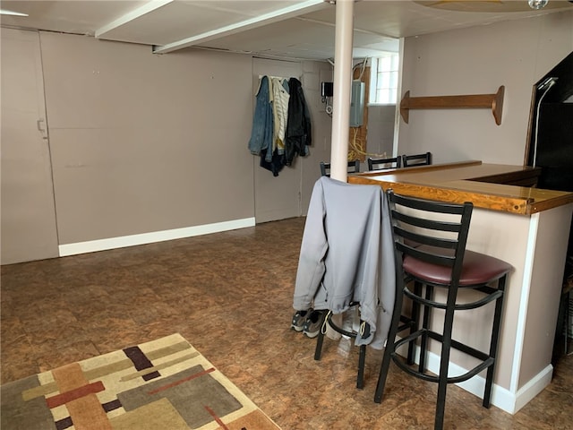 interior space with dark tile flooring and bar