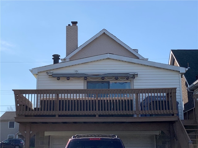 rear view of property featuring a garage