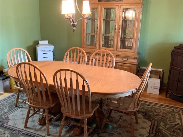 dining space with dark hardwood / wood-style floors and a chandelier