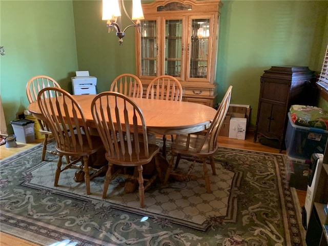 dining area with a notable chandelier and hardwood / wood-style flooring