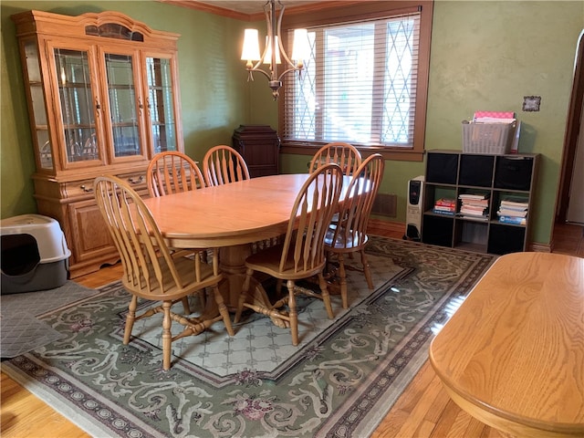 dining space featuring a notable chandelier and light hardwood / wood-style flooring