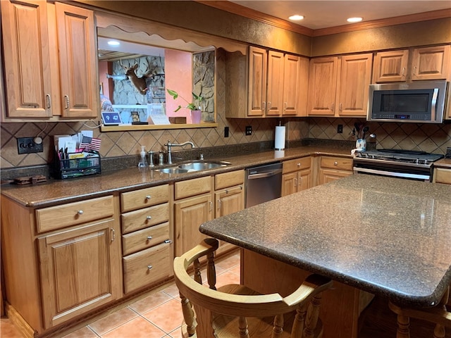 kitchen with light tile floors, a kitchen bar, tasteful backsplash, and stainless steel appliances