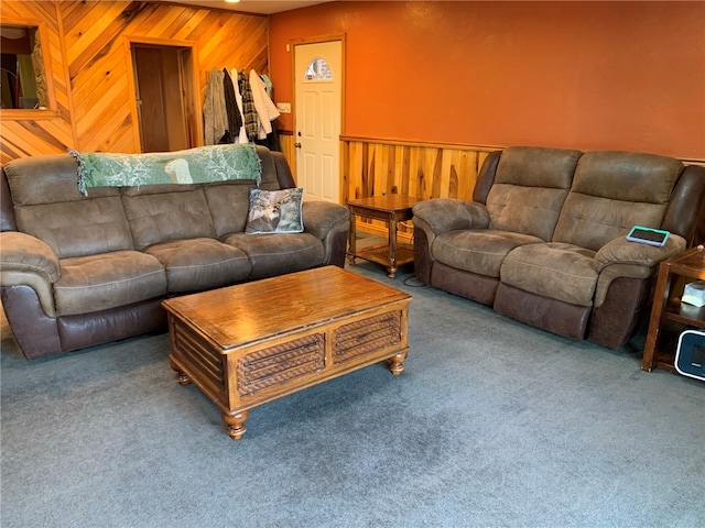 living room featuring carpet flooring and wood walls