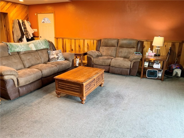 living room featuring carpet floors and wood walls