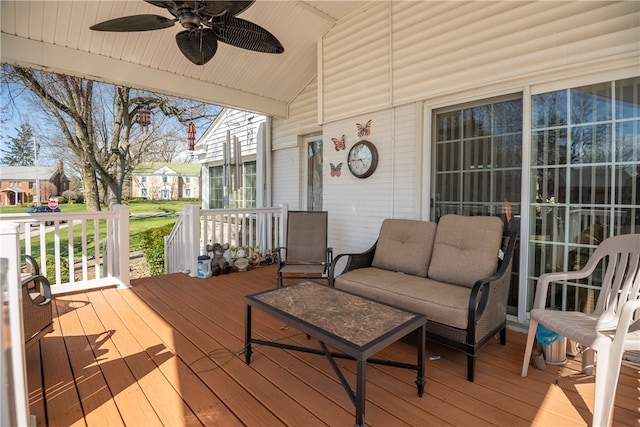 wooden deck featuring ceiling fan