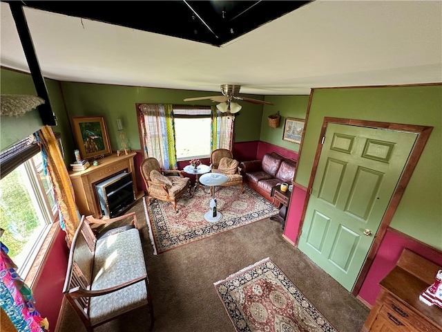 living room with vaulted ceiling, carpet floors, a healthy amount of sunlight, and ceiling fan