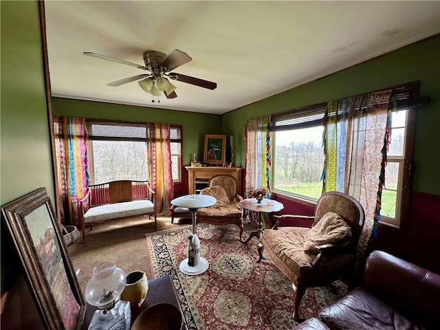 carpeted living room featuring ceiling fan