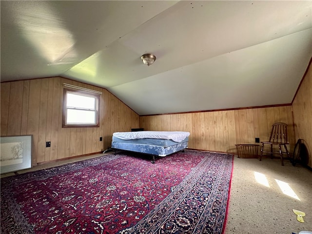 unfurnished bedroom with wooden walls, lofted ceiling, and carpet