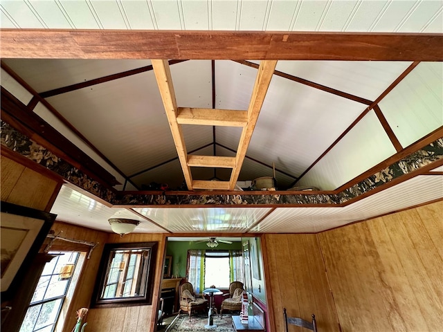 interior space featuring hardwood / wood-style floors, lofted ceiling, wood walls, and ceiling fan