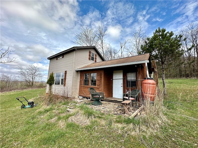 rear view of house with a yard