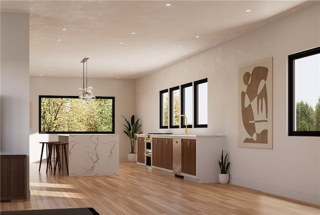 dining area featuring an inviting chandelier and light hardwood / wood-style floors