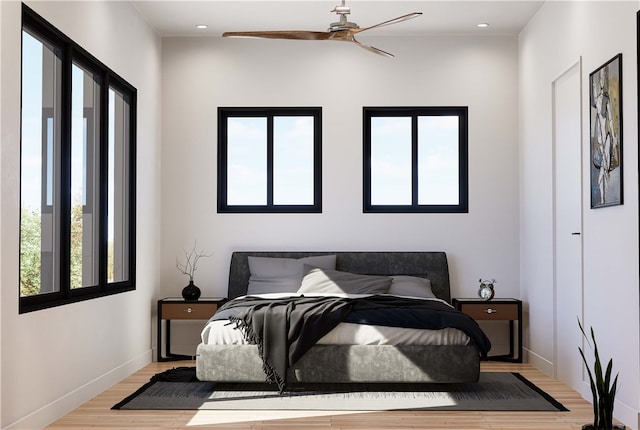 bedroom with ceiling fan and light wood-type flooring