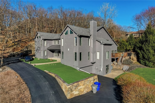 view of front facade with a front yard and a deck