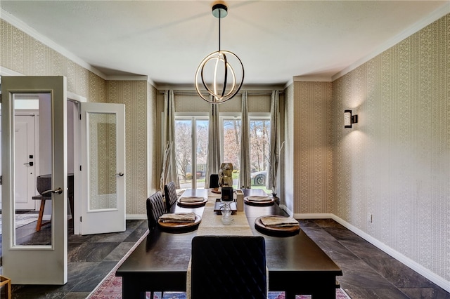 dining room featuring an inviting chandelier, ornamental molding, dark tile flooring, and french doors