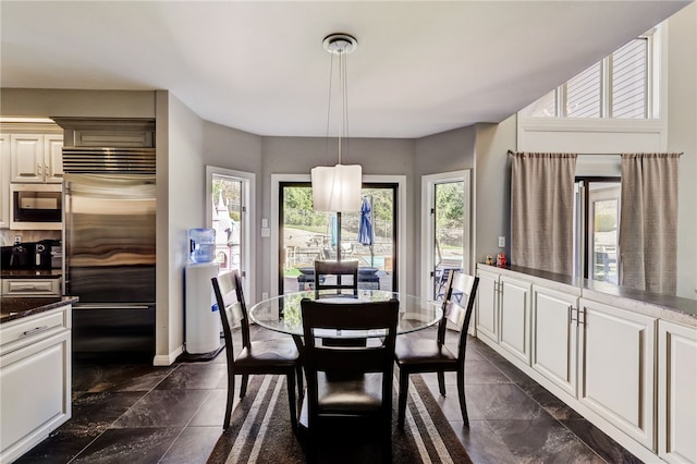 tiled dining area featuring a wealth of natural light