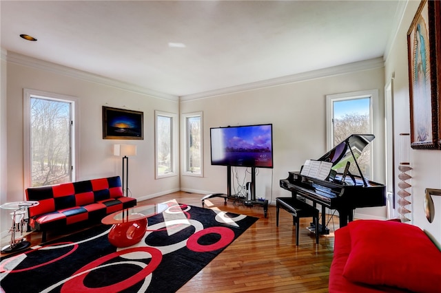 living area featuring ornamental molding, wood-type flooring, and a wealth of natural light