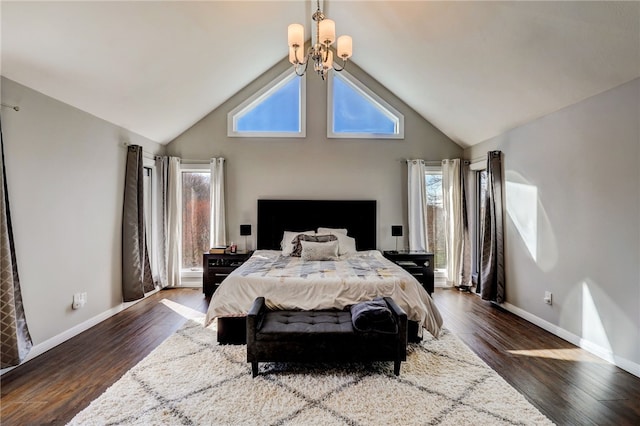 bedroom featuring a chandelier, dark wood-type flooring, and high vaulted ceiling