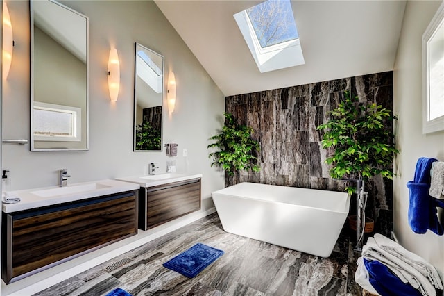 bathroom featuring lofted ceiling with skylight, tile walls, a wealth of natural light, and dual bowl vanity