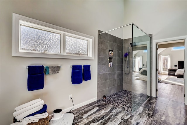 bathroom featuring walk in shower, tile floors, and a healthy amount of sunlight