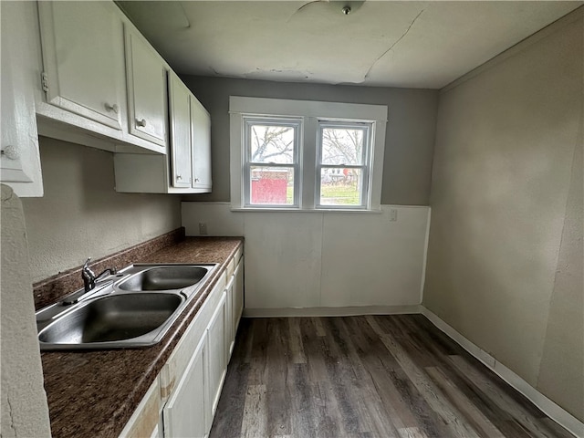 kitchen featuring sink, white cabinetry, and dark hardwood / wood-style flooring