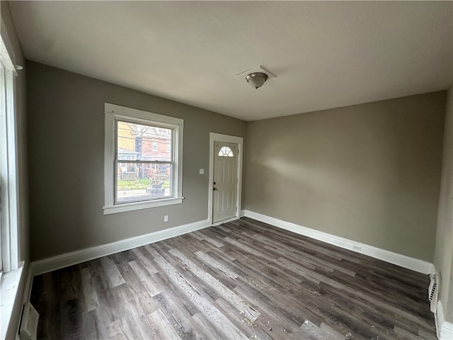 spare room with dark wood-type flooring