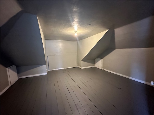 additional living space with lofted ceiling and dark hardwood / wood-style floors