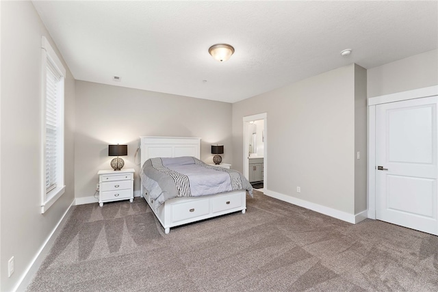 carpeted bedroom featuring connected bathroom