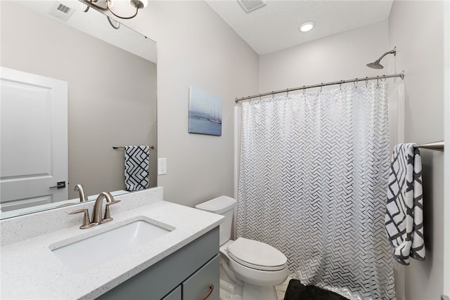 bathroom featuring tile flooring, vanity, and toilet