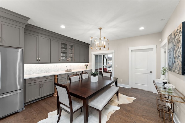 dining space featuring a notable chandelier and dark wood-type flooring