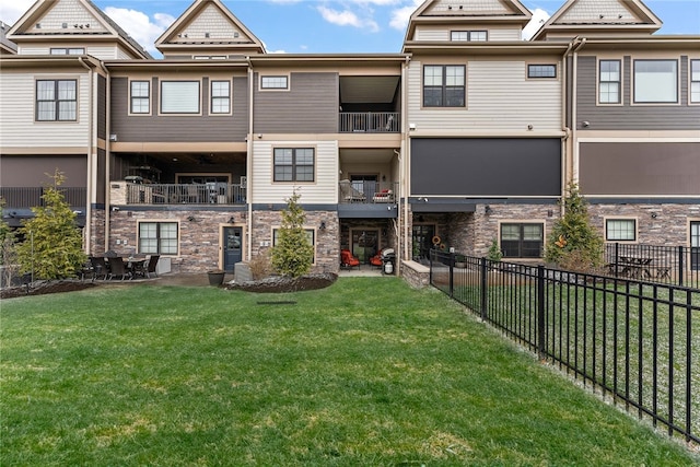 exterior space with a balcony and a lawn