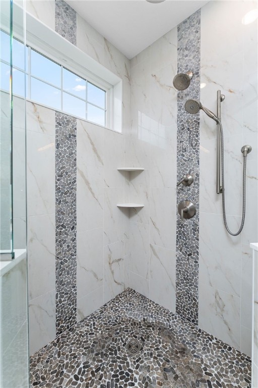 bathroom with a tile shower