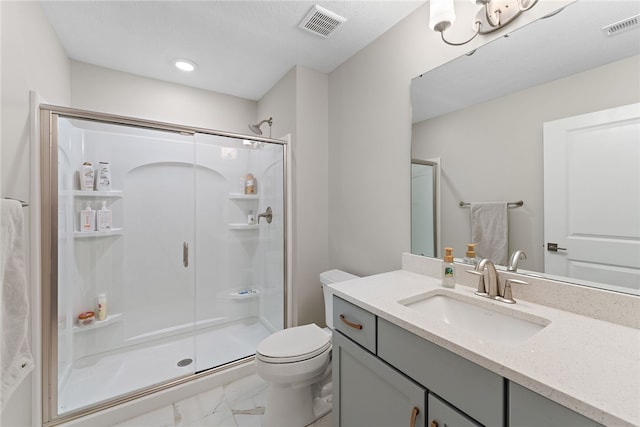 bathroom featuring walk in shower, tile floors, vanity, toilet, and a textured ceiling