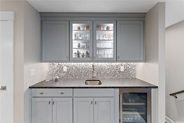 bar featuring wine cooler, sink, and gray cabinetry