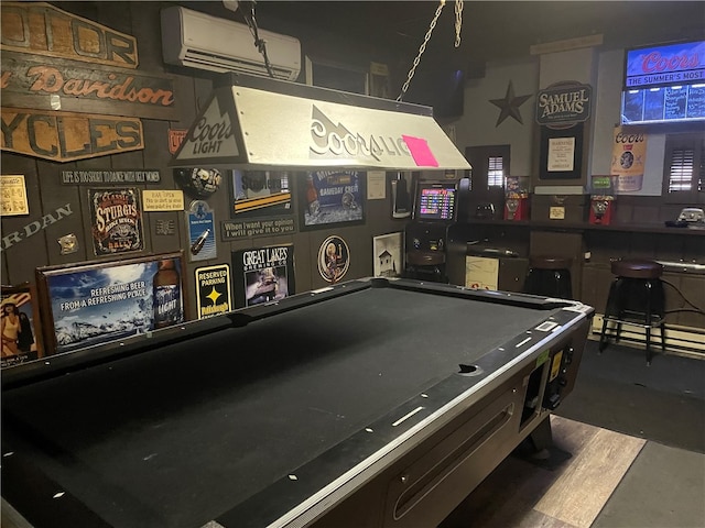 rec room with dark hardwood / wood-style floors, a wall mounted AC, pool table, and bar