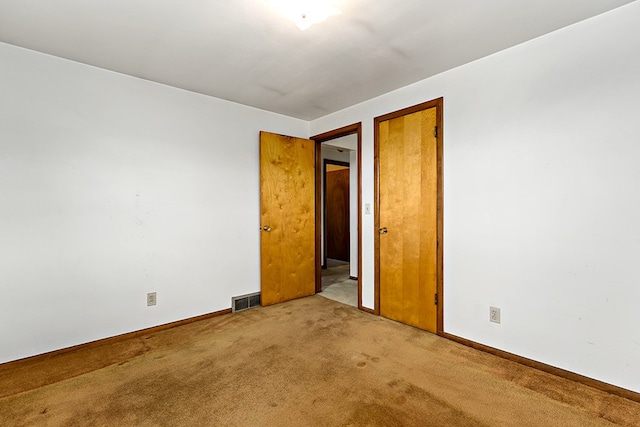 unfurnished room with light carpet