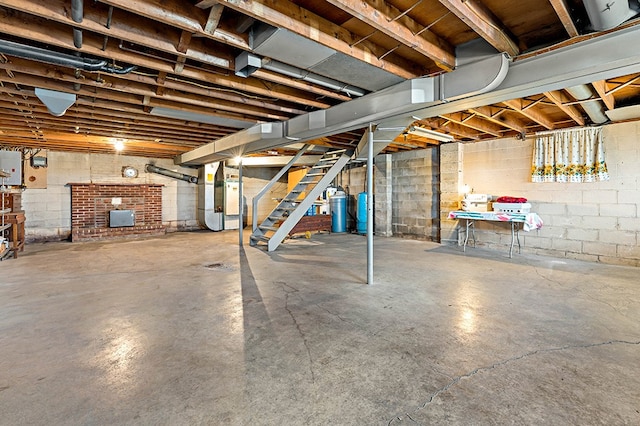 basement with heating utilities and a fireplace