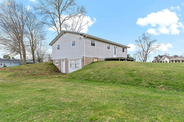 rear view of property with a lawn