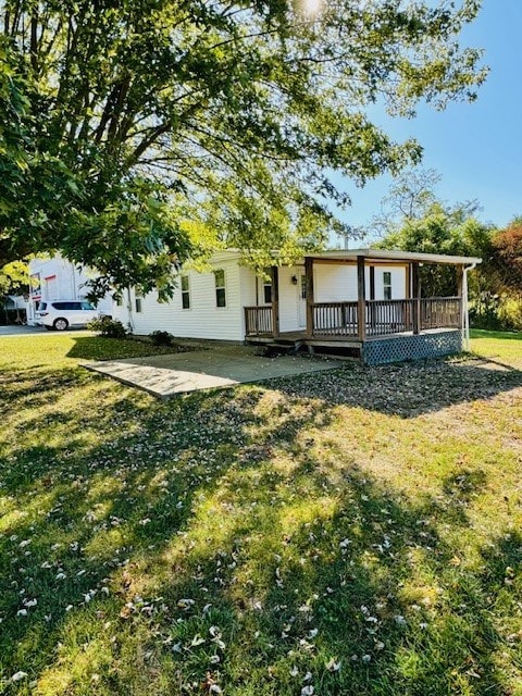 view of front of property with a front yard and a wooden deck