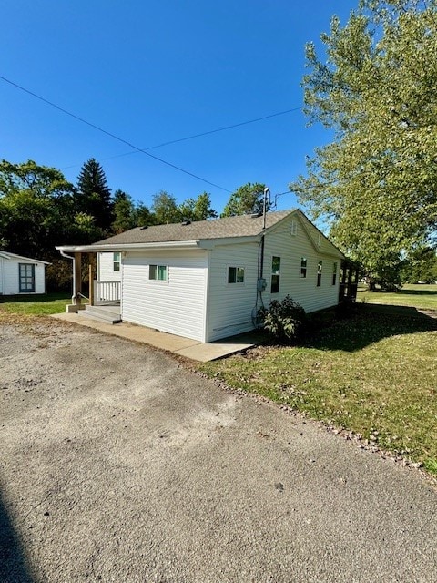 view of side of home with a yard