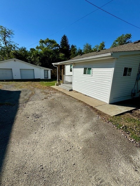 view of home's exterior featuring an outdoor structure and a garage