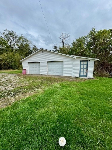 garage featuring a lawn