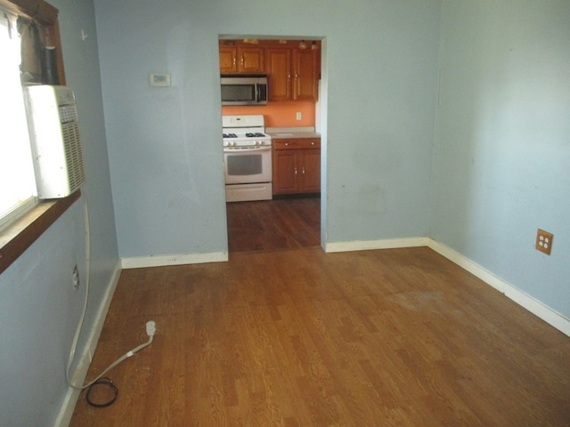 kitchen featuring white gas range oven and dark hardwood / wood-style flooring