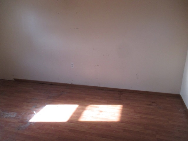 unfurnished room featuring dark wood-type flooring